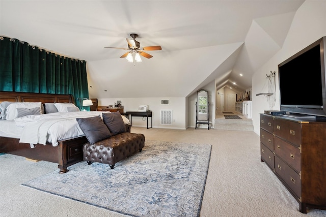 carpeted bedroom with ceiling fan and vaulted ceiling