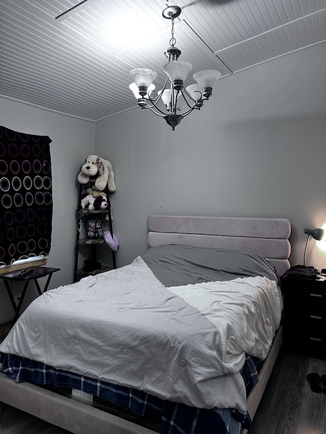 bedroom featuring dark hardwood / wood-style floors and a notable chandelier