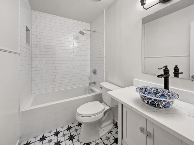 full bathroom featuring toilet, vanity, and tiled shower / bath