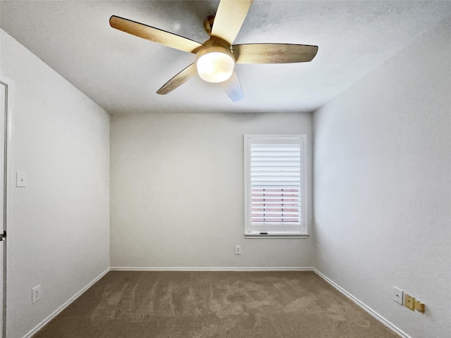 unfurnished room featuring ceiling fan and dark colored carpet