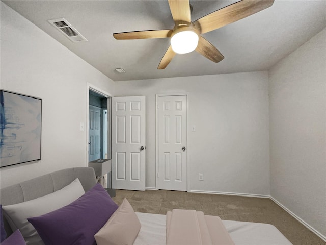 living room featuring ceiling fan and carpet