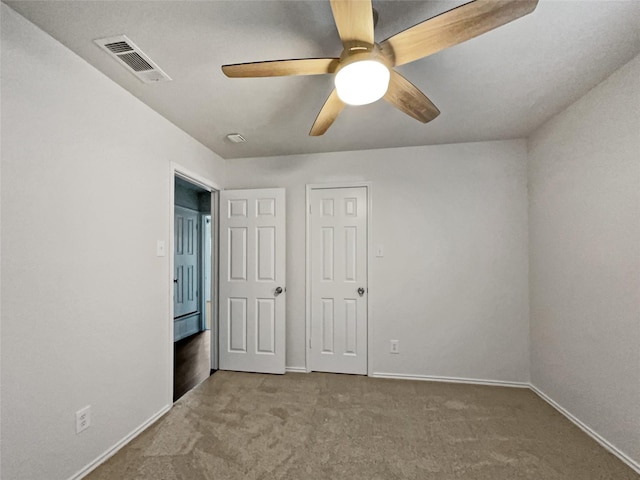 unfurnished bedroom featuring ceiling fan and carpet flooring