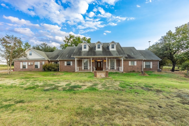 cape cod-style house with a front lawn and a porch