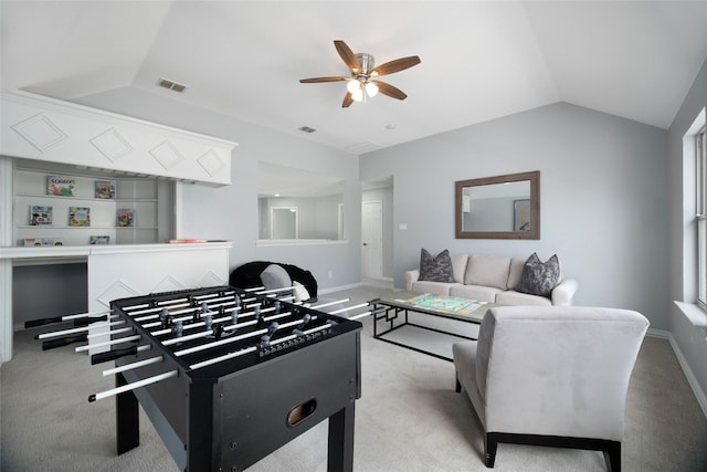 carpeted living room featuring ceiling fan and vaulted ceiling