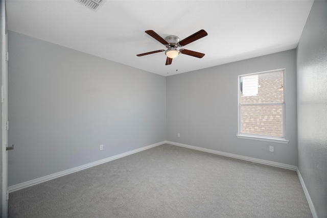 carpeted empty room featuring ceiling fan