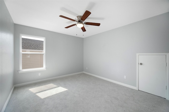 carpeted spare room with ceiling fan