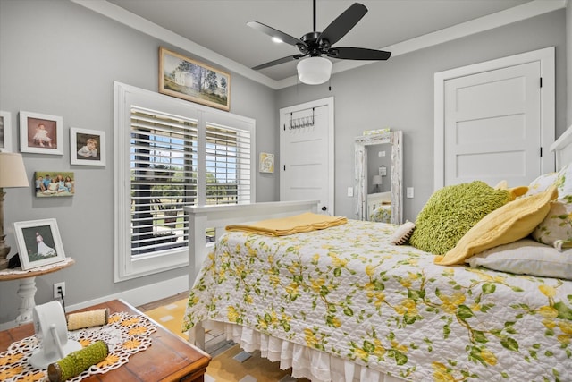 bedroom with ceiling fan and crown molding