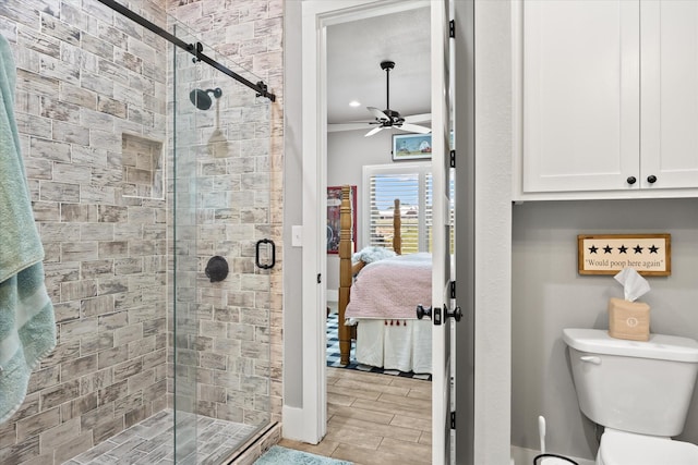 bathroom with ceiling fan, an enclosed shower, and toilet