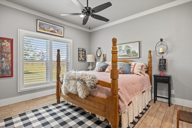 bedroom featuring multiple windows, ceiling fan, and ornamental molding