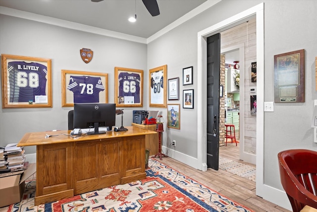 office area with wood-type flooring, ceiling fan, and ornamental molding