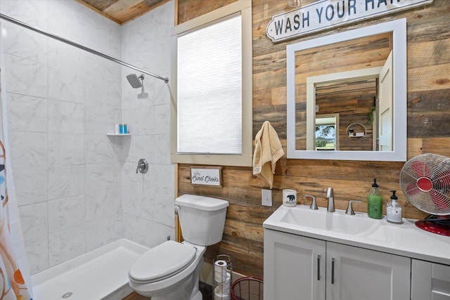 bathroom featuring a shower with shower curtain, vanity, wood walls, and toilet