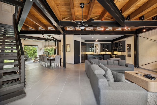 living room with light tile patterned flooring, beamed ceiling, wooden ceiling, and ceiling fan