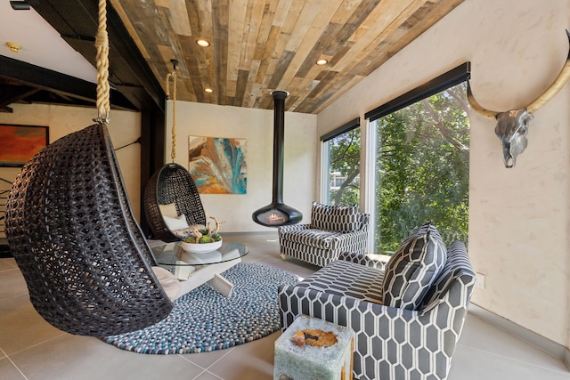 interior space featuring wooden ceiling and a wood stove