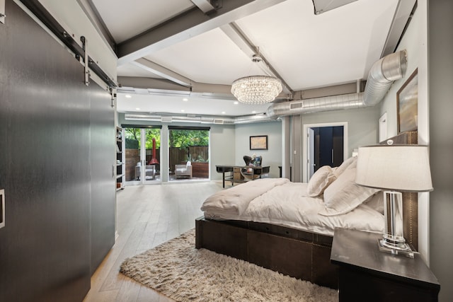 bedroom featuring light hardwood / wood-style floors, a notable chandelier, a barn door, and beamed ceiling