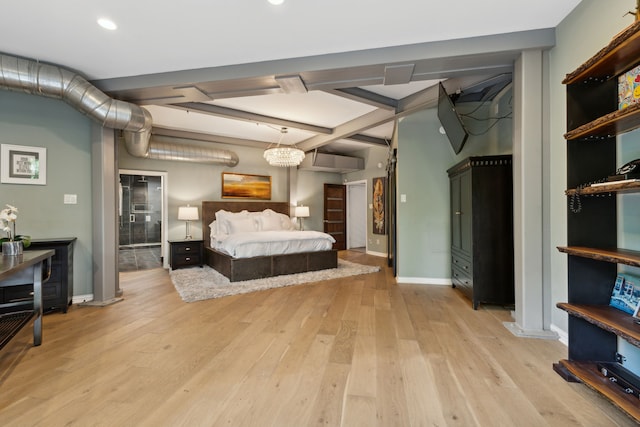 bedroom with beamed ceiling and light hardwood / wood-style floors