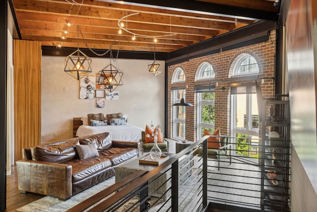 living room featuring wood-type flooring and brick wall