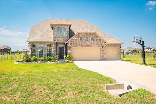 view of front of house with a garage and a front lawn