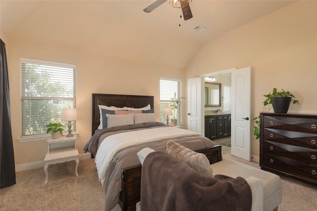 carpeted bedroom featuring ceiling fan, lofted ceiling, and ensuite bathroom