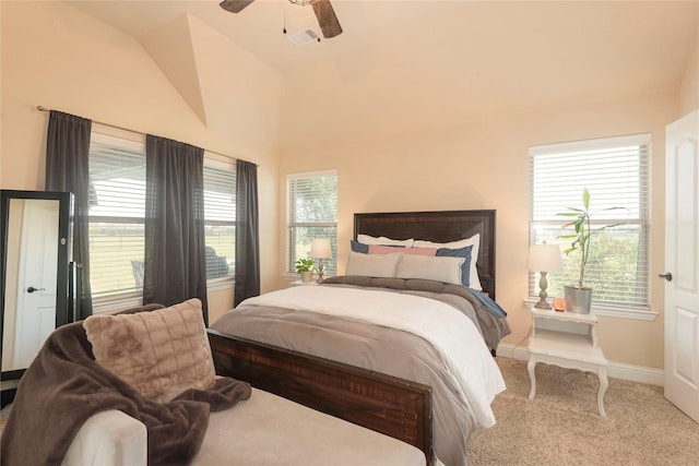 bedroom featuring multiple windows, vaulted ceiling, ceiling fan, and carpet flooring