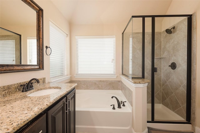 bathroom featuring vanity and shower with separate bathtub