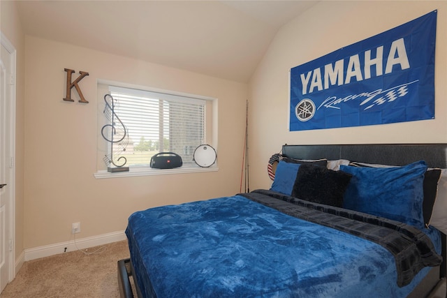 carpeted bedroom with vaulted ceiling