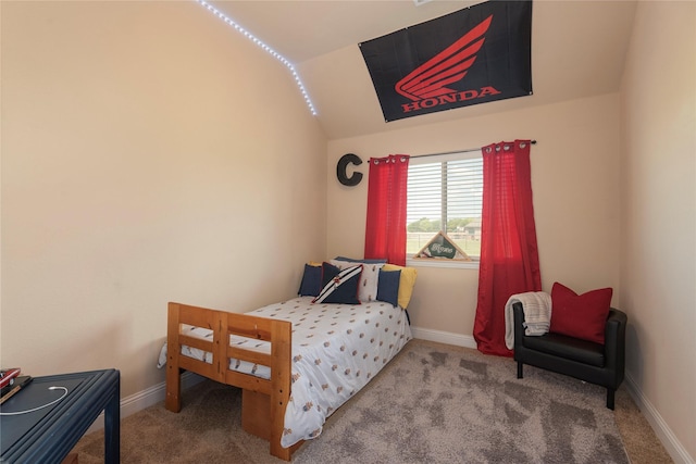 carpeted bedroom with lofted ceiling