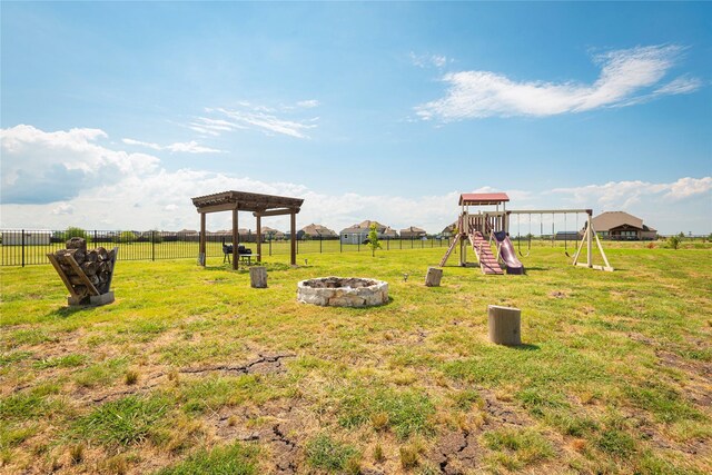 view of yard with a playground and an outdoor fire pit