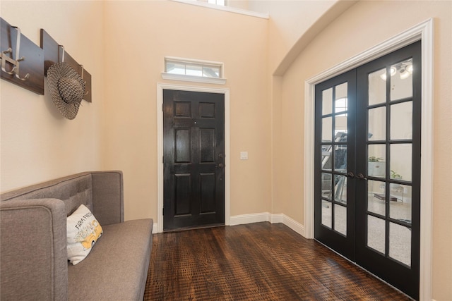 entryway with dark carpet and french doors