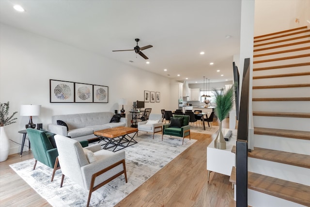 living room featuring ceiling fan and light hardwood / wood-style floors