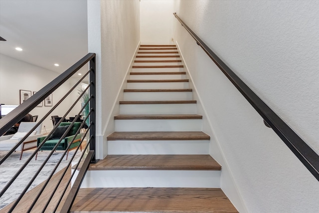 stairway with hardwood / wood-style floors