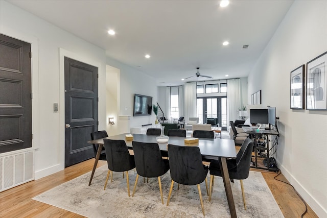 dining space featuring light hardwood / wood-style flooring and ceiling fan