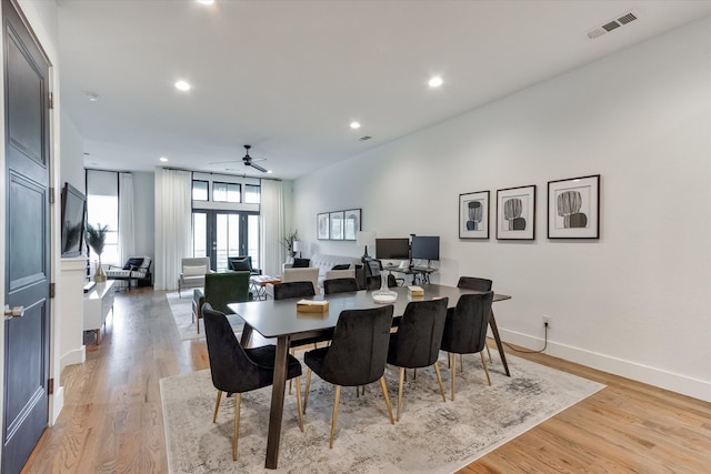 dining room with french doors, light hardwood / wood-style flooring, and ceiling fan