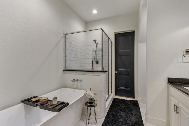 bathroom with vanity, independent shower and bath, and tile patterned floors