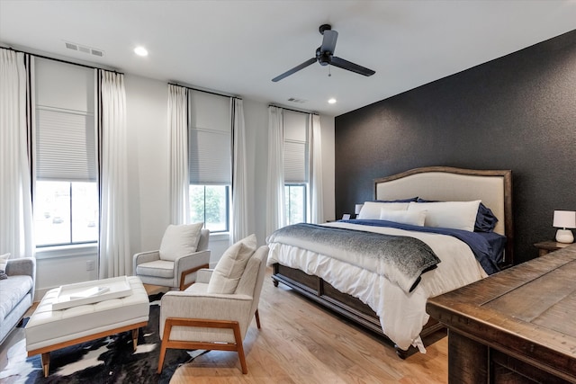 bedroom with light hardwood / wood-style floors and ceiling fan