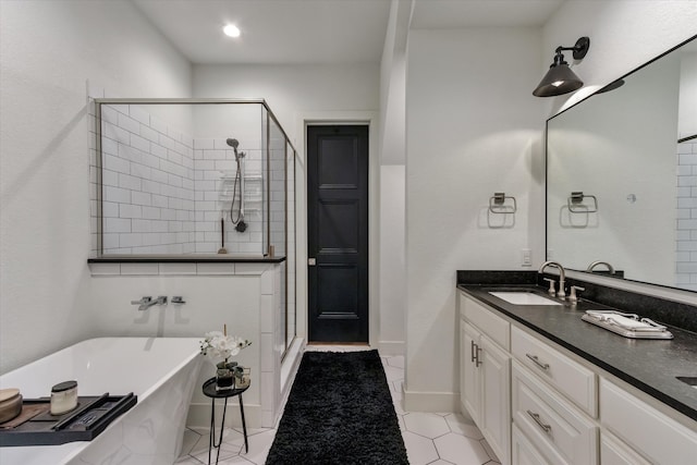 bathroom with plus walk in shower, vanity, and tile patterned floors