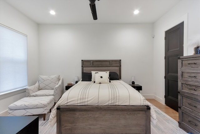 bedroom with light hardwood / wood-style flooring and ceiling fan