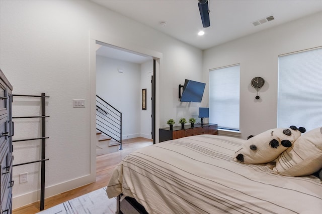 bedroom with light wood-type flooring and ceiling fan