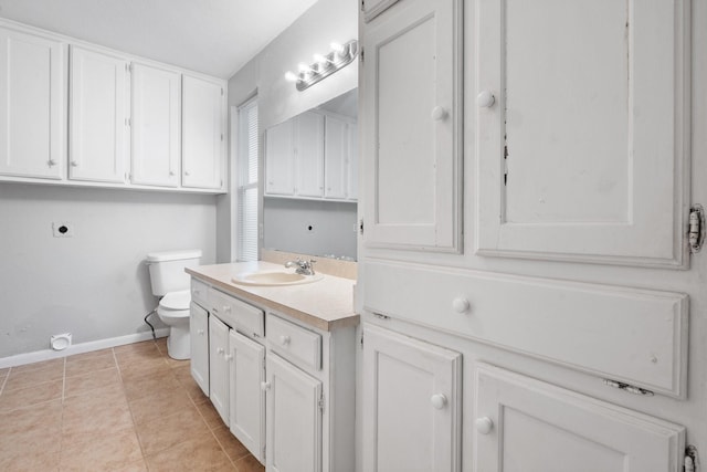 bathroom featuring tile patterned flooring, vanity, and toilet