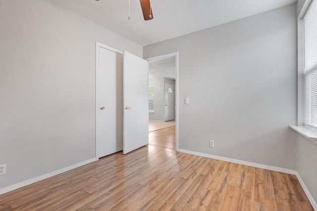 empty room featuring ceiling fan and light hardwood / wood-style flooring