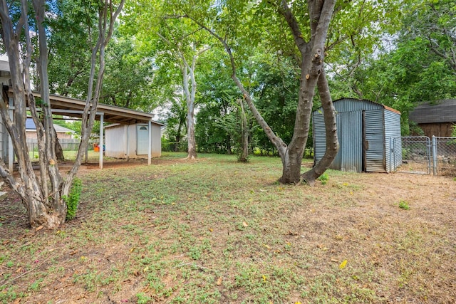 view of yard featuring a shed and a carport