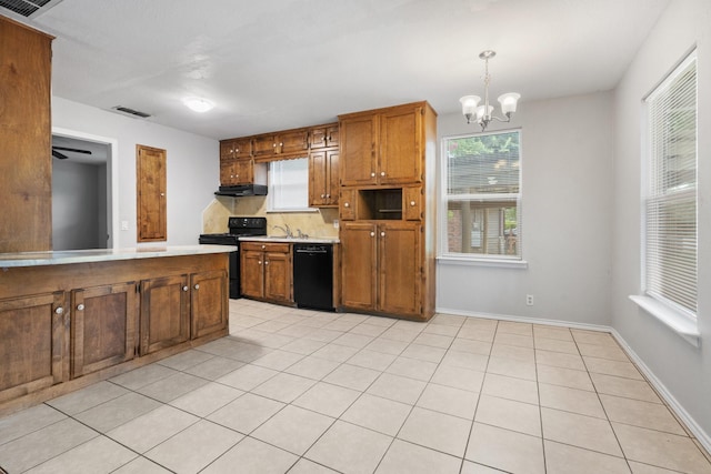 kitchen featuring black appliances, pendant lighting, light tile patterned floors, and extractor fan