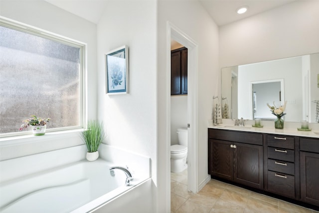 bathroom featuring a bathing tub, vanity, and toilet