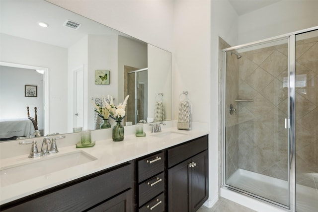 bathroom featuring tile patterned flooring, vanity, and walk in shower