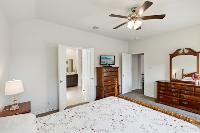 bedroom featuring carpet, ensuite bathroom, and ceiling fan