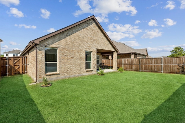 rear view of house with a yard