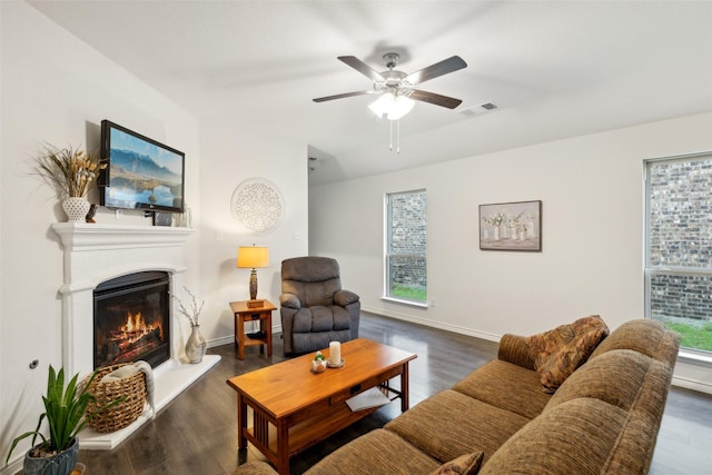 living room featuring ceiling fan and dark wood-type flooring