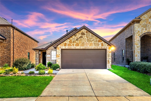 view of front of property featuring a lawn and a garage