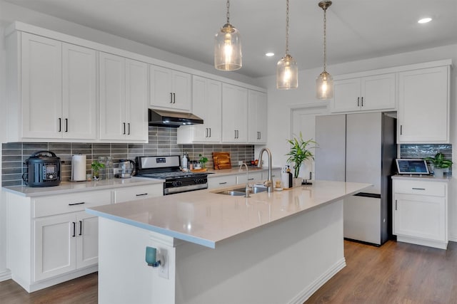 kitchen featuring sink, white cabinets, range hood, a center island with sink, and appliances with stainless steel finishes