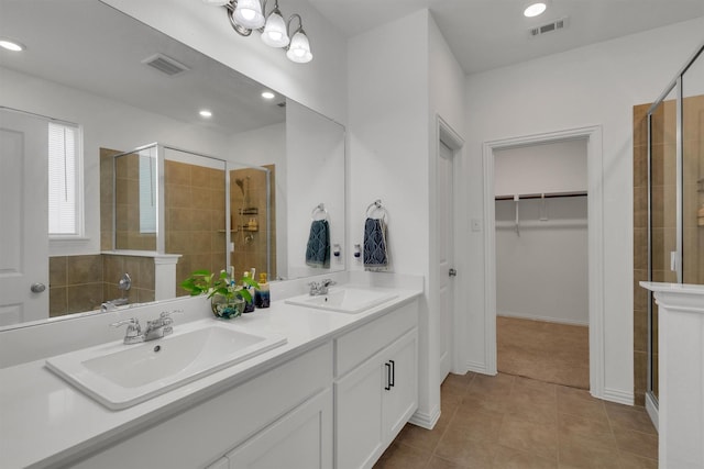 bathroom with vanity, walk in shower, and tile patterned floors