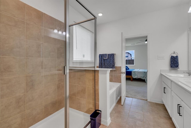 bathroom with ceiling fan, vanity, an enclosed shower, and tile patterned floors